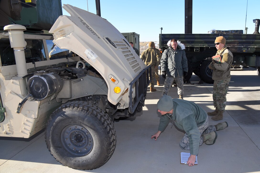 Master Sgt. Andrew Bowman (left) and Staff Sgt. Zachary Witt, both 729th Air Control Squadron, perform a joint technical inspection for vehicles during a readiness exercise Jan. 31 2019, at Hill Air Force Base, Utah. (U.S. Air Force photo by Todd Cromar)