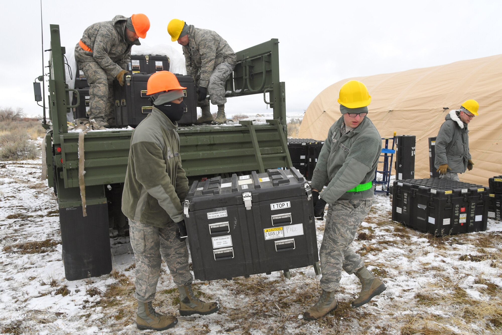 Airmen with the 729th Air Control Squadron unload equipment from vehicles Feb. 5, 2019, during a readiness exercise at Hill Air Force Base, Utah. The evolution was part of an exercise to mobilize and set up a deployed radar location and control reporting center. (U.S. Air Force photo by Todd Cromar)