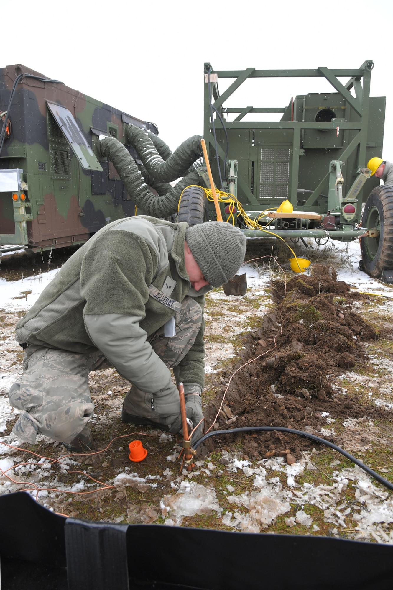 Airman 1st Class Thomas Juillerat, 729th Air Control Squadron, hooks up an equipment grounding wire, Feb. 5, 2019, during a readiness exercise at Hill Air Force Base, Utah. The evolution was part of an exercise to mobilize and set up a deployed radar location and control reporting center. (U.S. Air Force photo by Todd Cromar)
