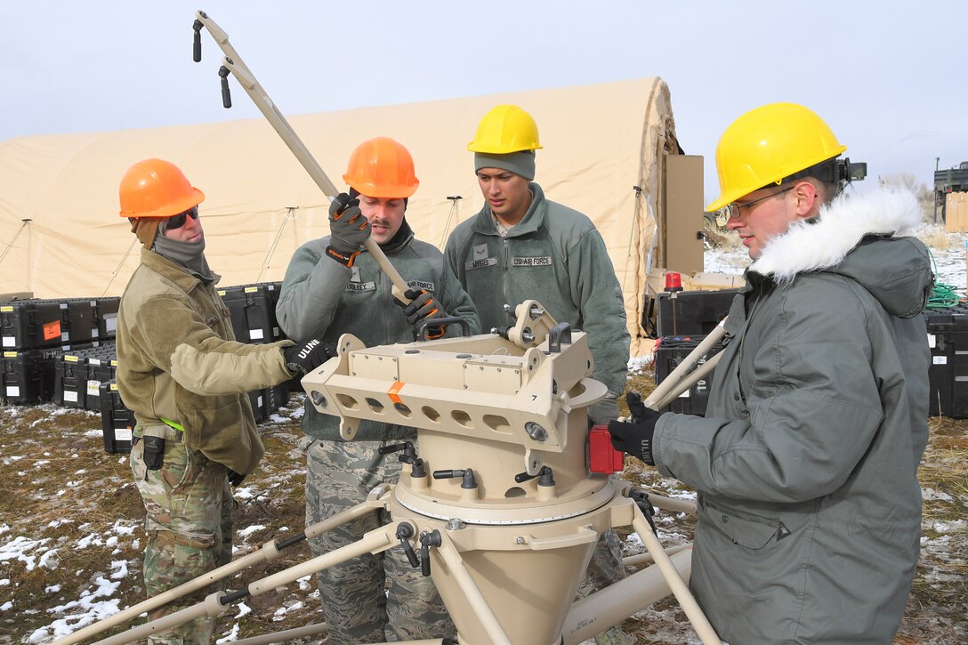 Airmen with the 729th Air Control Squadron set up a communications antenna Feb. 5, 2019, during a readiness exercise at Hill Air Force Base, Utah. The evolution was part of an exercise to mobilize and set up a deployed radar location and control reporting center. (U.S. Air Force photo by Todd Cromar)