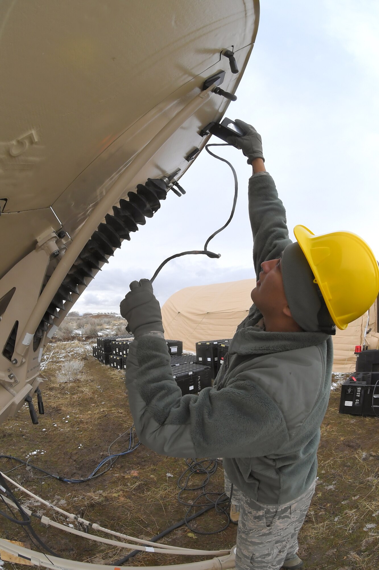 Airman 1st Class Austin Myers, 729th Air Control Squadron, plug cables into a communications antenna Feb. 5 2019, during a readiness exercise at Hill Air Force Base, Utah. The evolution was part of an exercise to mobilize and set up a deployed radar location and control reporting center. (U.S. Air Force photo by Todd Cromar)