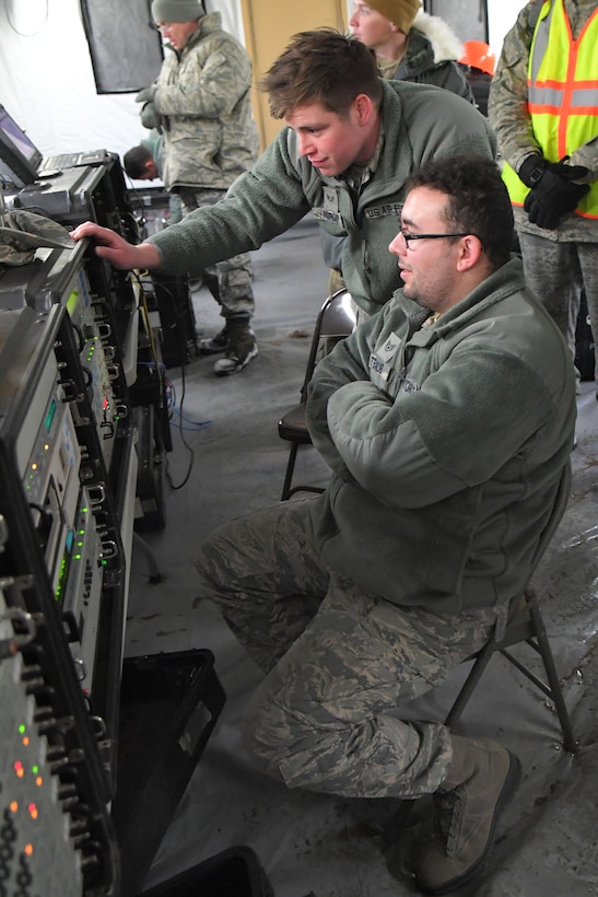 Staff Sgt. Devin Traub (seated) and Senior Airman David Nordin, both 729th Air Control Squadron, monitor communications equipment Feb. 6, 2019, during a readiness exercise at Hill Air Force Base, Utah. The evolution was part of an exercise to mobilize and set up a deployed radar location and control reporting center. (U.S. Air Force photo by Todd Cromar)