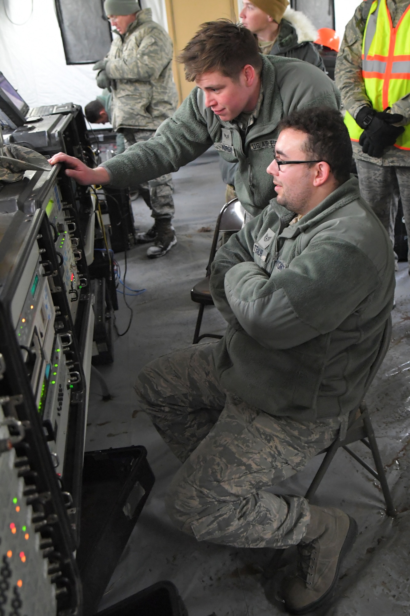 Staff Sgt. Devin Traub (seated) and Senior Airman David Nordin, both 729th Air Control Squadron, monitor communications equipment Feb. 6, 2019, during a readiness exercise at Hill Air Force Base, Utah. The evolution was part of an exercise to mobilize and set up a deployed radar location and control reporting center. (U.S. Air Force photo by Todd Cromar)