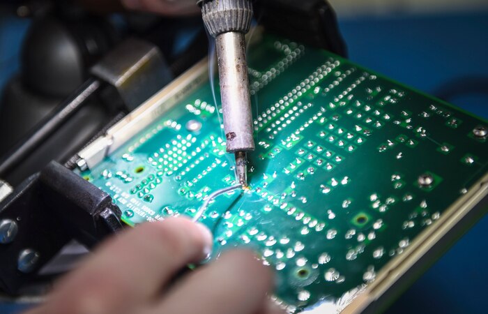 A circuit board gets soldered.