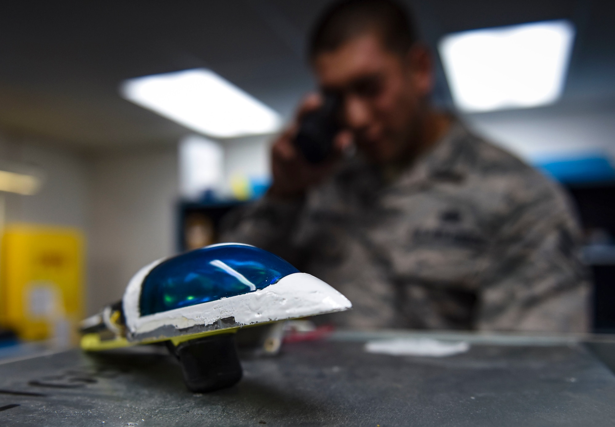 An Airman look at a navigation light.