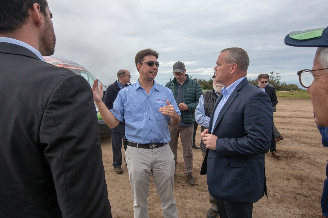 Deputy assistant secretary of defense Judd H. Lyons and Justin Bollum, the airport manager for Catalina Island's Airport in the Sky, discuss the outstanding achievements made by Marine Wing Support Squadron (MWSS ) 373, Marine Wing Support Group (MWSG) 37, 3rd Marine Aircraft Wing (MAW) as they replace the airport's runway on Catalina Island, Calif., March 1. The “Airport in the Sky” project falls under the Department of Defense innovative readiness training program.  3rd MAW's partnership with the Catalina Island Conservancy is a unique opportunity for Marines to conduct applicable training while also helping the community. (U.S. Marine Corps photo by Lance Cpl. Juan Anaya)