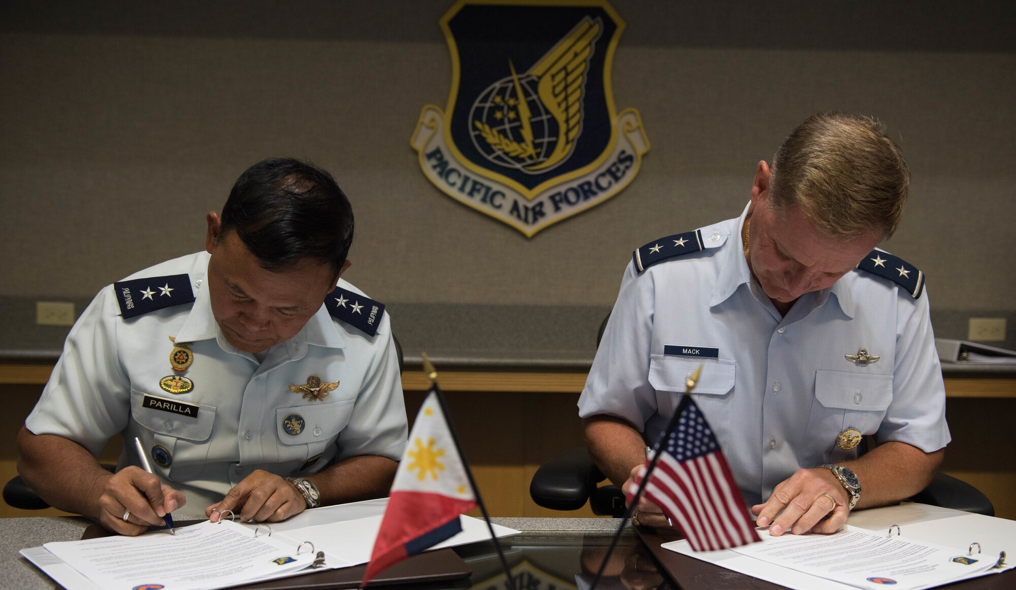 Philippine air force (PAF) Maj. Gen. Nicolas C. Parilla (right), PAF acting vice commander, and U.S. Air Force Maj. Gen. Russell Mack, Pacific Air Forces (PACAF) deputy commander, sign the meeting minutes after the closing remarks during PAF-PACAF Airman-to-Airman talks, at Joint Base Pearl Harbor-Hickam, Hawaii, Feb. 27, 2019.