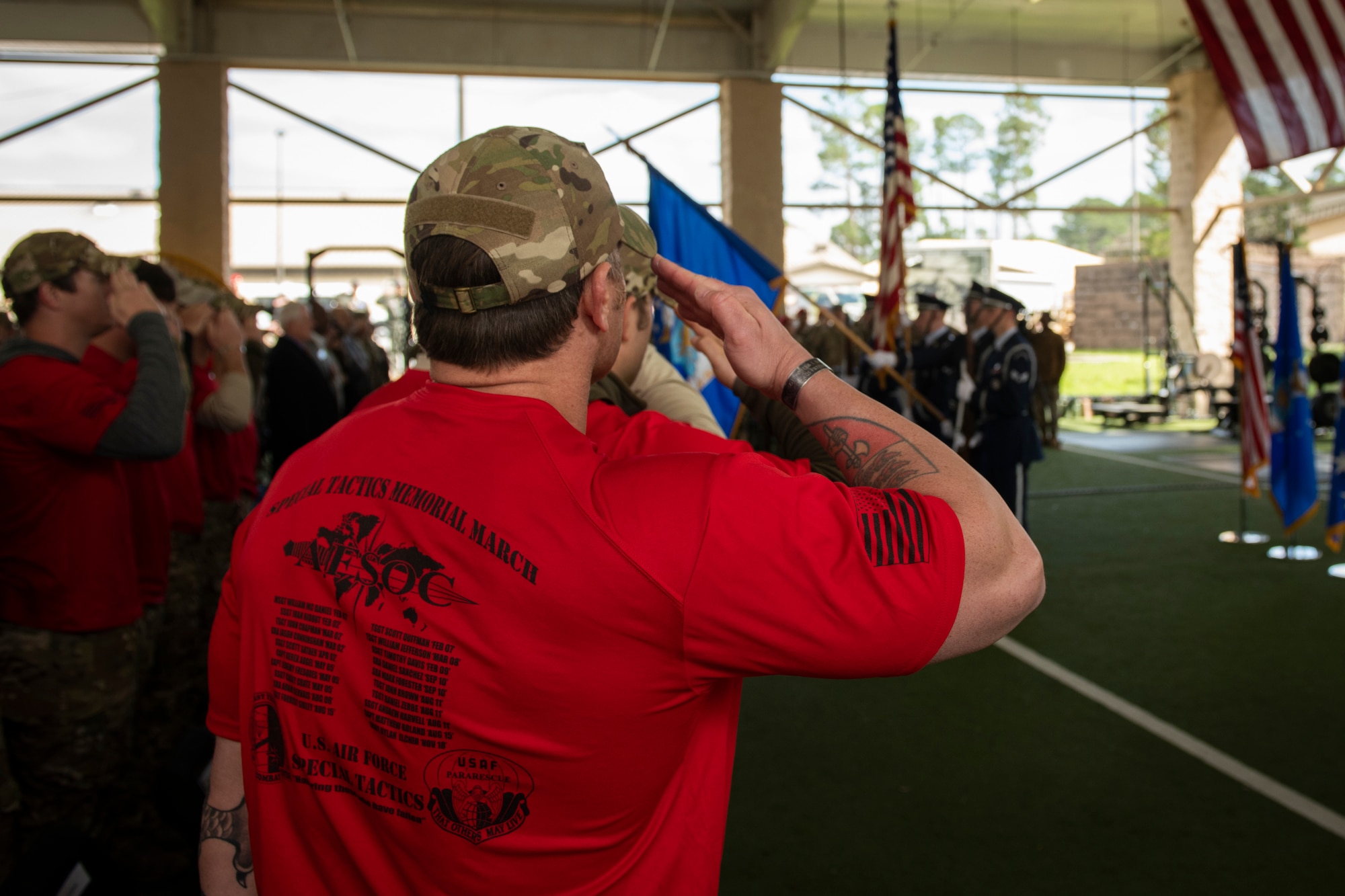A Special Tactics Airman with the 24th Special Operations Wing salutes during the presentation of colors during the Special Tactics Ruck March Memorial Ceremony at Hurlburt Field, Florida, March 4, 2018.