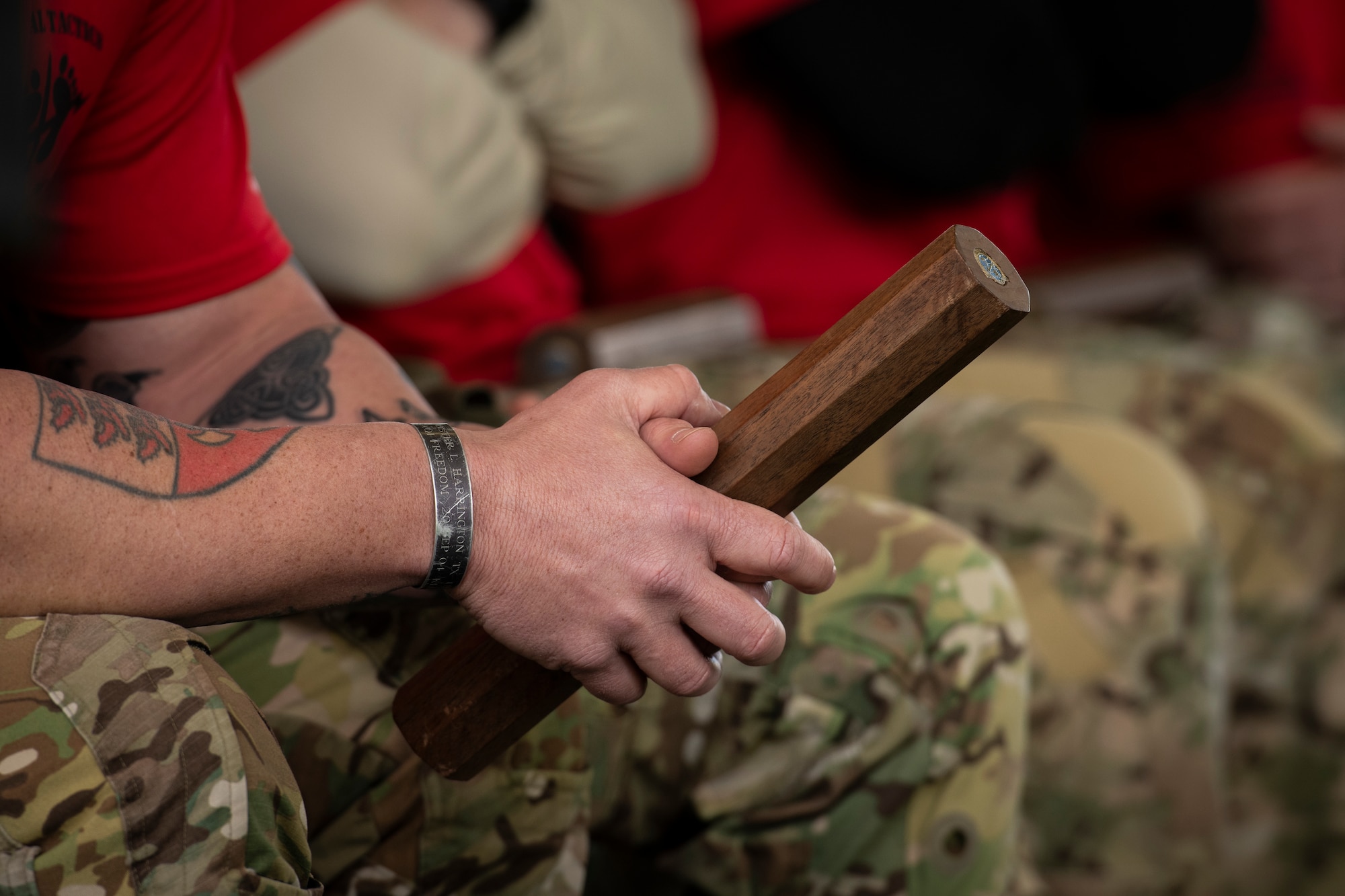 A Special Tactics Airman with the 24th Special Operations Wing holds the baton carrying the name of a fallen brethren during the Special Tactics Ruck March Memorial Ceremony at Hurlburt Field, Florida, March 4, 2018.