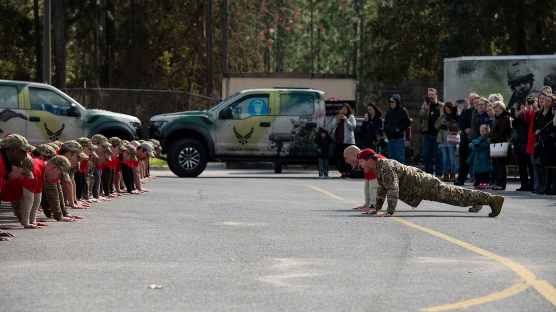Special Tactics senior leaders with the 24th Special Operations Wing lead hundreds of Air Commandos, teammates and family in performing memorial push-ups following the Special Tactics Ruck March Memorial Ceremony at Hurlburt Field, Florida, March 4, 2018.