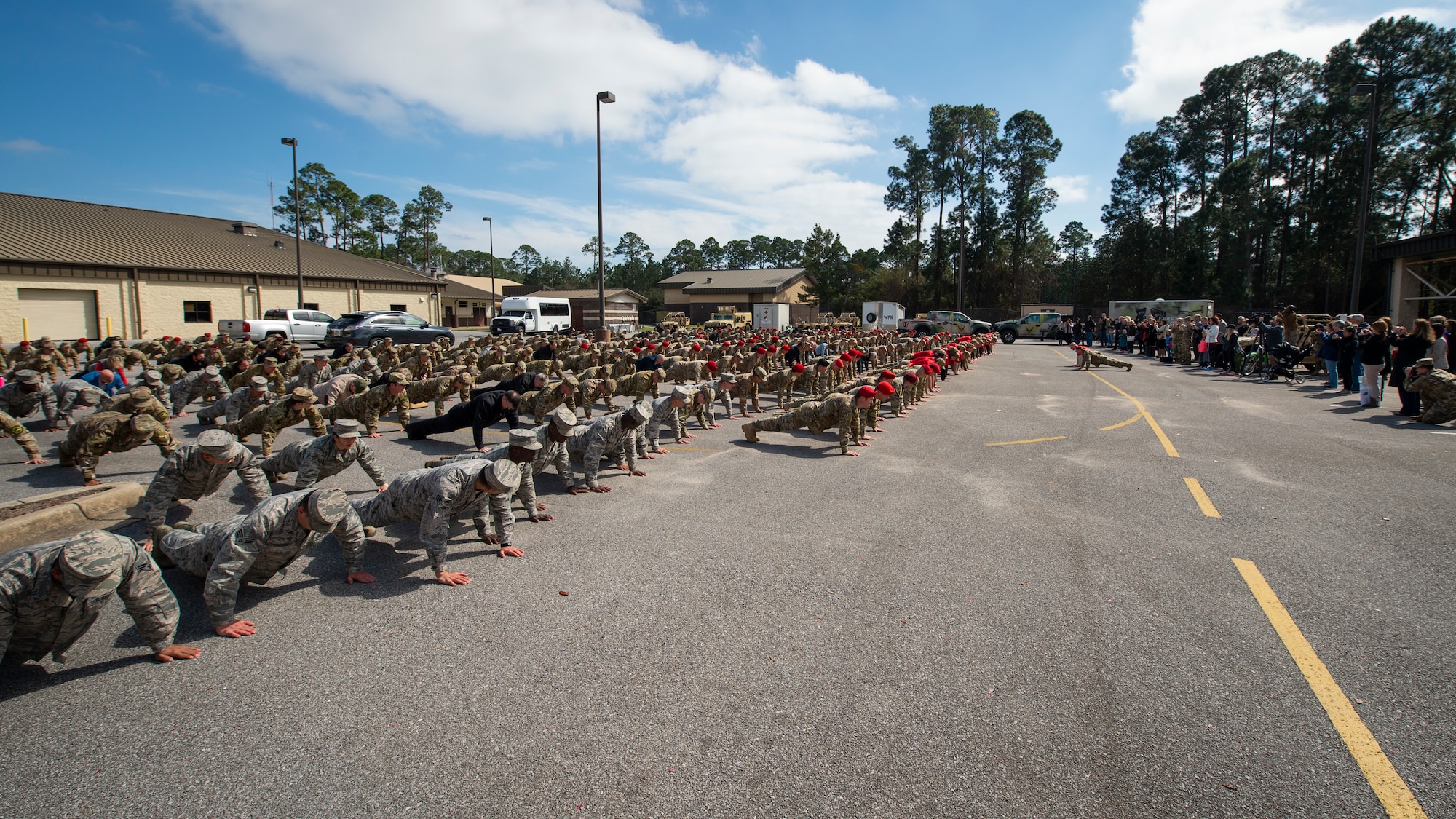 Special Tactics senior leaders with the 24th Special Operations Wing lead hundreds of Air Commandos, teammates and family in performing memorial push-ups following the Special Tactics Ruck March Memorial Ceremony at Hurlburt Field, Florida, March 4, 2018.