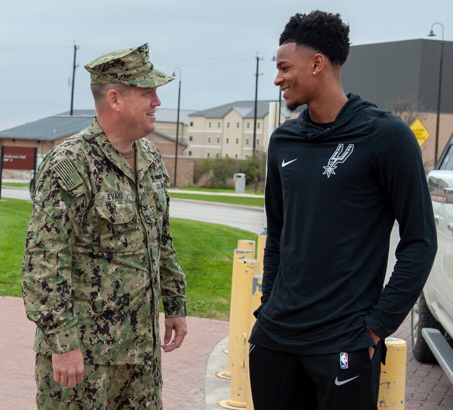 Capt. Eric Evans, executive officer of Navy Medicine Training Support Center, greets San Antonio Spurs player Dejounte Murray, upon his arrival to the Medical Education and Training Campus. Murray's visit was organized ahead of the Spurs' Navy-themed Military Salute Night.