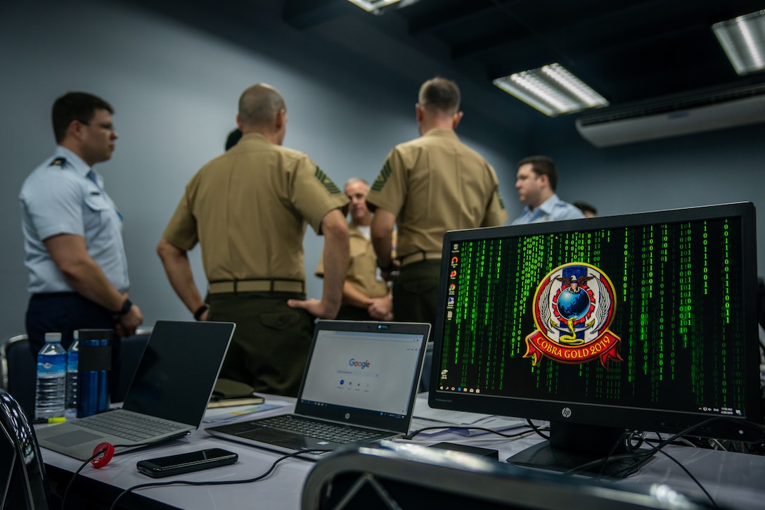 U.S. Marines and U.S. Air Force service members discuss defensive cyber operations during the cyber range as part of exercise Cobra Gold at the Royal Thai Air Force Headquarters in Bangkok, Kingdom of Thailand, Feb. 20, 2019. The cyber range is a bilateral simulated computer exercise that focuses on identifying critical vulnerabilities within a network and working together to correct those deficiencies. Cobra Gold demonstrates the commitment of the Kingdom of Thailand and the United States to our long-standing alliance, promotes regional partnerships and advances security cooperation in the Indo-Pacific region. (U.S. Marine Corps photo by Staff Sgt. Matthew J. Bragg)