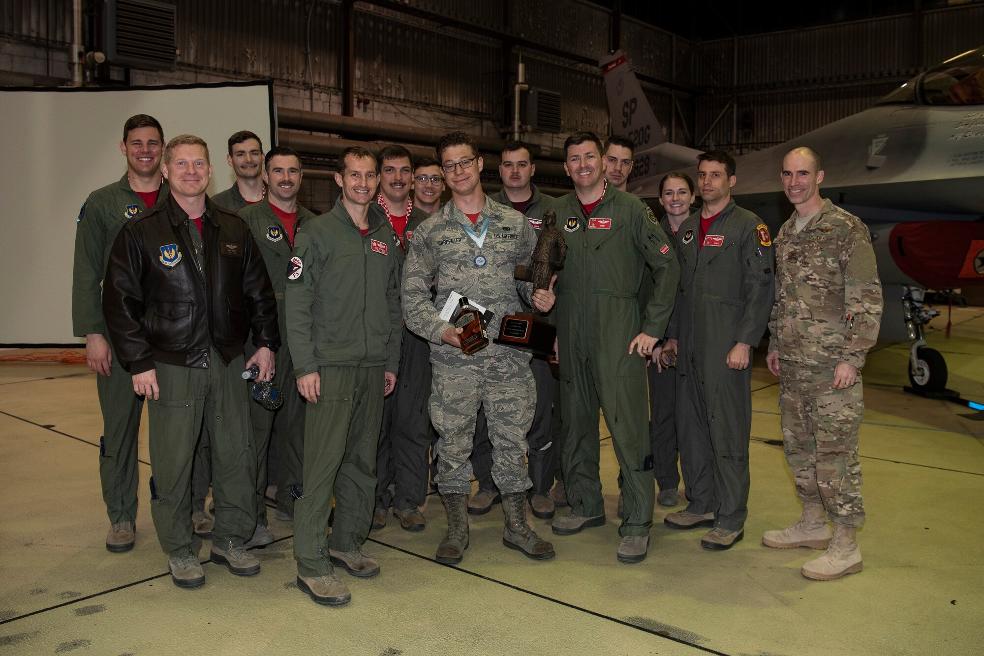 U.S. Air Force Col. Jason Bailey, 52nd Fighter Wing commander, right, and other base leadership pose for a photo with Senior Airman Jaron Carpenter, 52nd Aircraft Maintenance Squadron assistant dedicated crew chief, center, during the 2018 Maintenance Professional of the Year banquet at Spangdahlem Air Base, Germany, March 1, 2019. The banquet allowed 52nd Maintenance Group leaders to recognize Spangdahlem's top maintainers of the year. Carpenter won 2018 Maintenance Professional of the Year in the Airman category. (U.S. Air Force photo by Airman 1st Class Valerie Seelye)