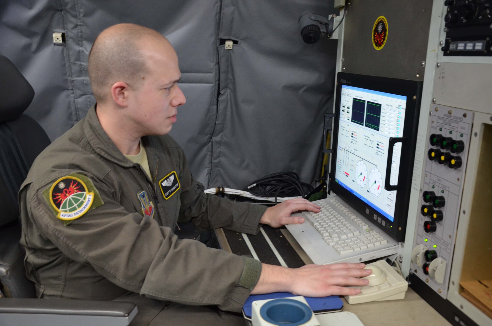 U.S. Air Force Staff Sgt. Theodore "TJ" Bencoter, a special equipment operator with the Air Force Technical Applications Center's Detachment 1 at Offutt AFB, Neb., reviews technical collection information aboard the WC-135 Constant Phoenix.  The aircraft was on display at Patrick AFB, Fla., for members of the nuclear treaty monitoring center and base personnel to tour.   (U.S. Air Force photo by Susan A. Romano)