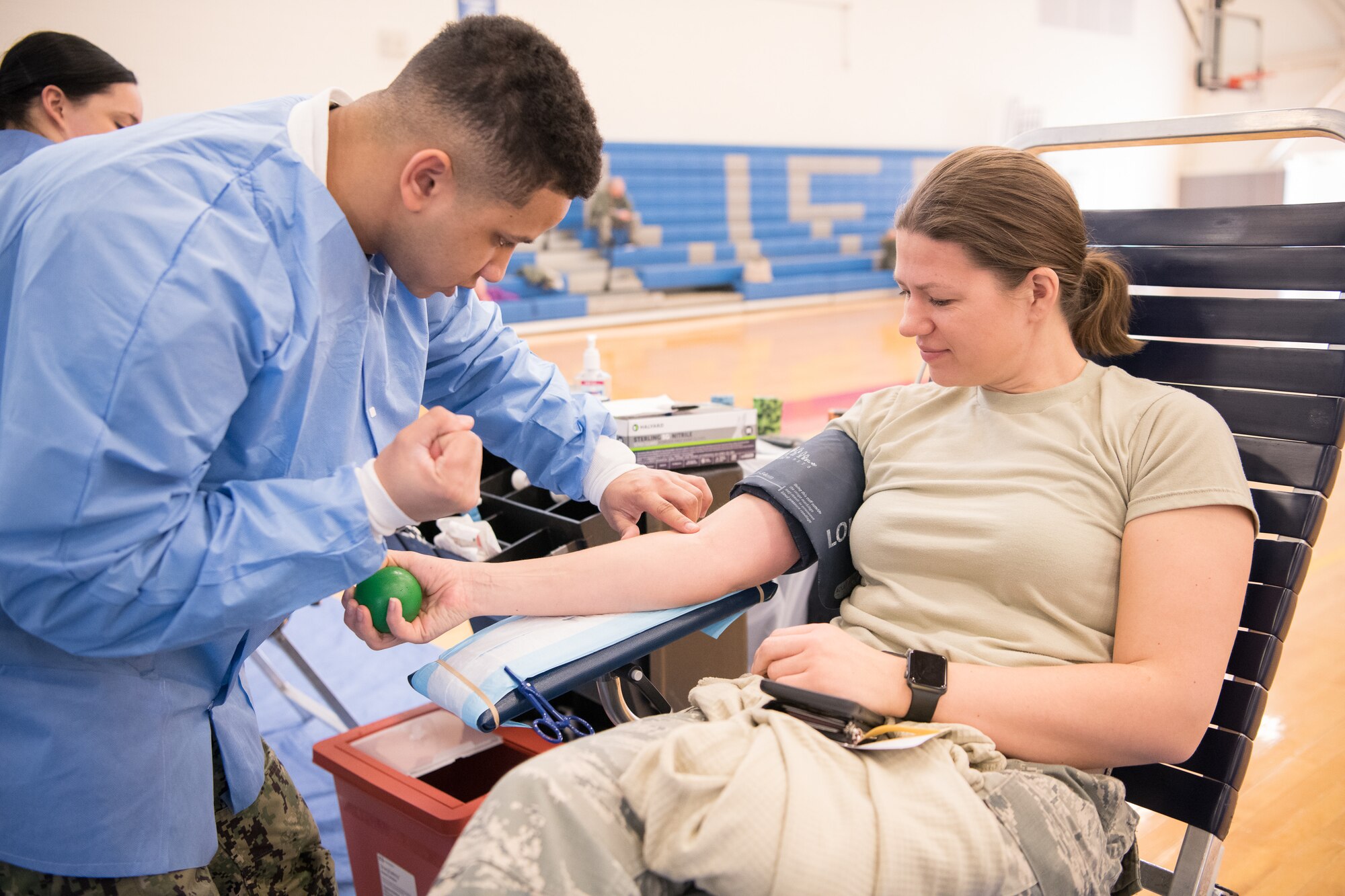 Hospital Apprentice Isaiah Burns, Walter Reed National Medical Center, searches for a vein on a donor’s arm at the Armed Services Blood Program blood drive Feb. 28, 2019, at Dover Air Force Base, Del. During times of both peace and war, the mission of the ASBP is to provide quality blood products in support of contingency operations, military exercises, VA hospitals and civilian emergencies worldwide. (U.S. Air Force Photo by Mauricio Campino)