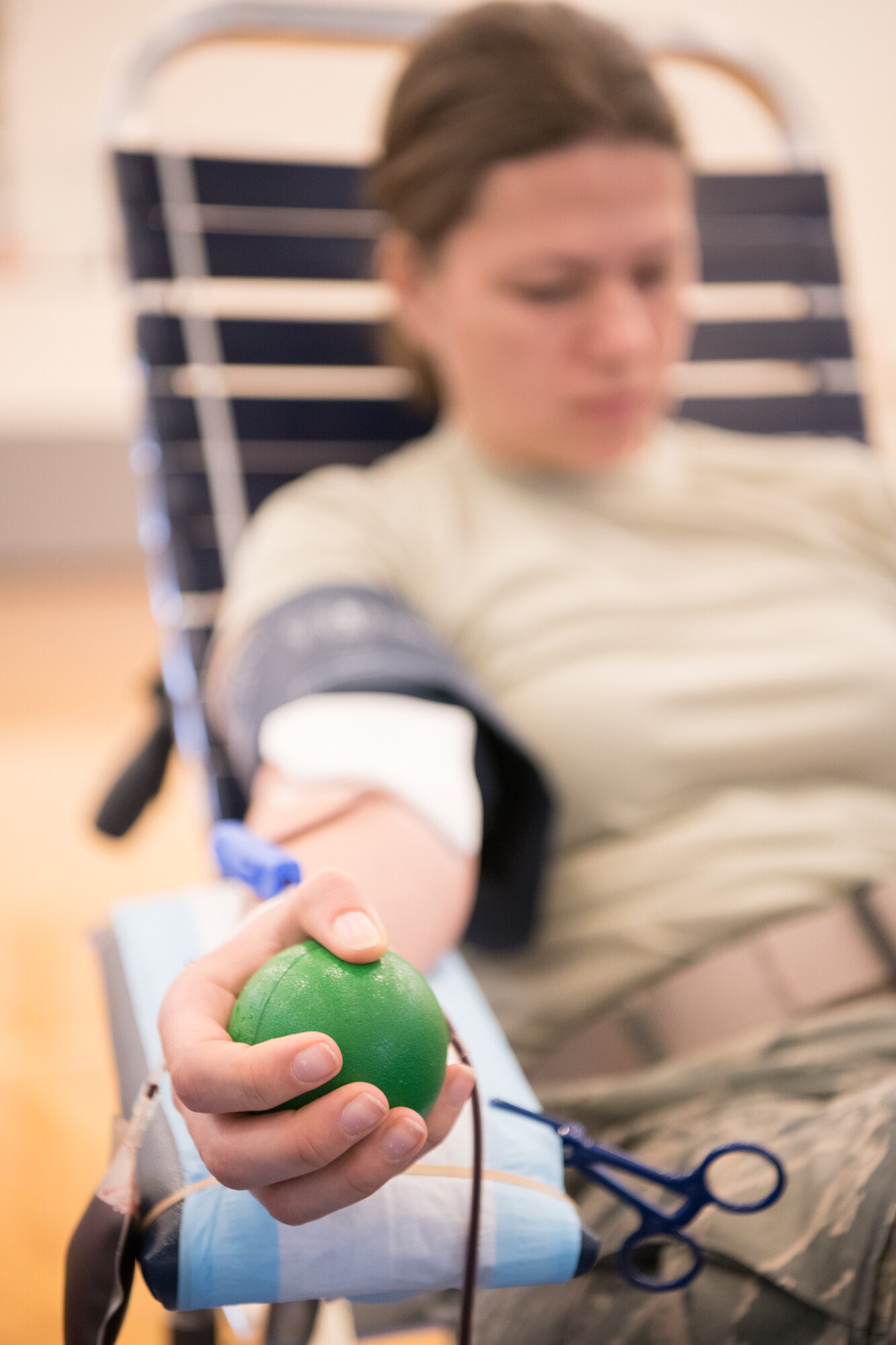 2nd Lt. Ekaterina Thormann, 436th Aerial Port Squadron air freight officer in charge, squeezes a rubber ball at the Armed Services Blood Program blood drive Feb. 28, 2019, at Dover Air Force Base, Del. Squeezing a rubber ball contracts the arm muscles and increases venous outflow into the blood collection bag, thereby expediting the donation process. 
(U.S. Air Force Photo by Mauricio Campino)