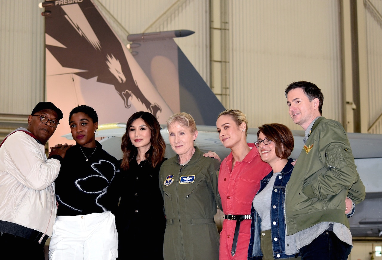 Captain Marvel cast take photo with airman in front of F-15