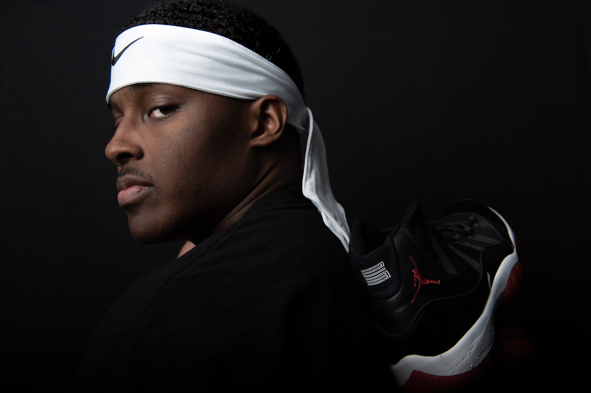U.S. Air Force Airman 1st Class Yaukis Cole 377th Weapons System Security Squadron, poses with his favorite pair of basketball shoes, retro Jordan 11 'breds" for a portrait at Kirtland Air Force Base, N.M. Cole is the team captain for the 377th WSSS and guarantees a championship for his squadron. (U.S. Air Force photo by Staff Sgt. J.D. Strong II)