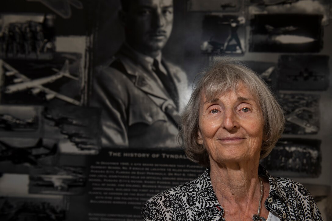 Mary Tyndall Troff, daughter of World War I pilot Lt. Frank B. Tyndall, 2nd Bombardment Group, stands in front of a heritage mural inside the 325th Fighter Wing headquarters building during a base visit at Tyndall Air Force Base, Fla., Feb. 25, 2019. Mary and her daughters were invited to visit TAFB after she sent a letter about her concerns for the base and the well-being of Airmen after Hurricane Michael. (U.S. Air Force photo by Staff Sgt. Alexandre Montes)