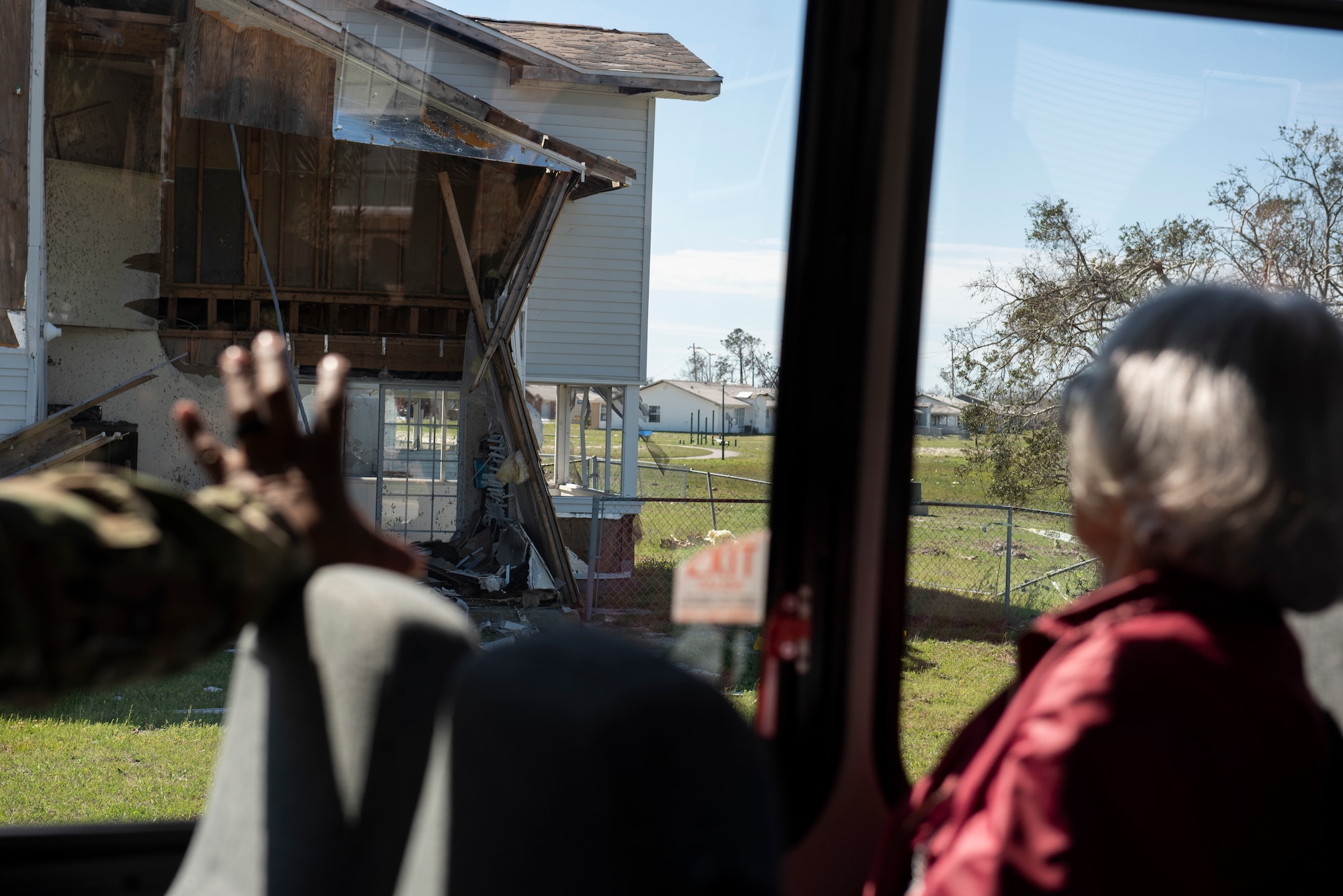 Mary Tyndall Troff, daughter of World War I pilot Lt. Frank B. Tyndall, 2nd Bombardment Group, looks out a window to see the destruction caused to the housing community by Hurricane Michael at Tyndall Air Force Base, Fla., Feb. 25, 2019. Mary and her daughters were invited to visit TAFB after she sent a letter about her concerns for the base and the well-being of Airmen after Hurricane Michael. (U.S. Air Force photo by Staff Sgt. Alexandre Montes)