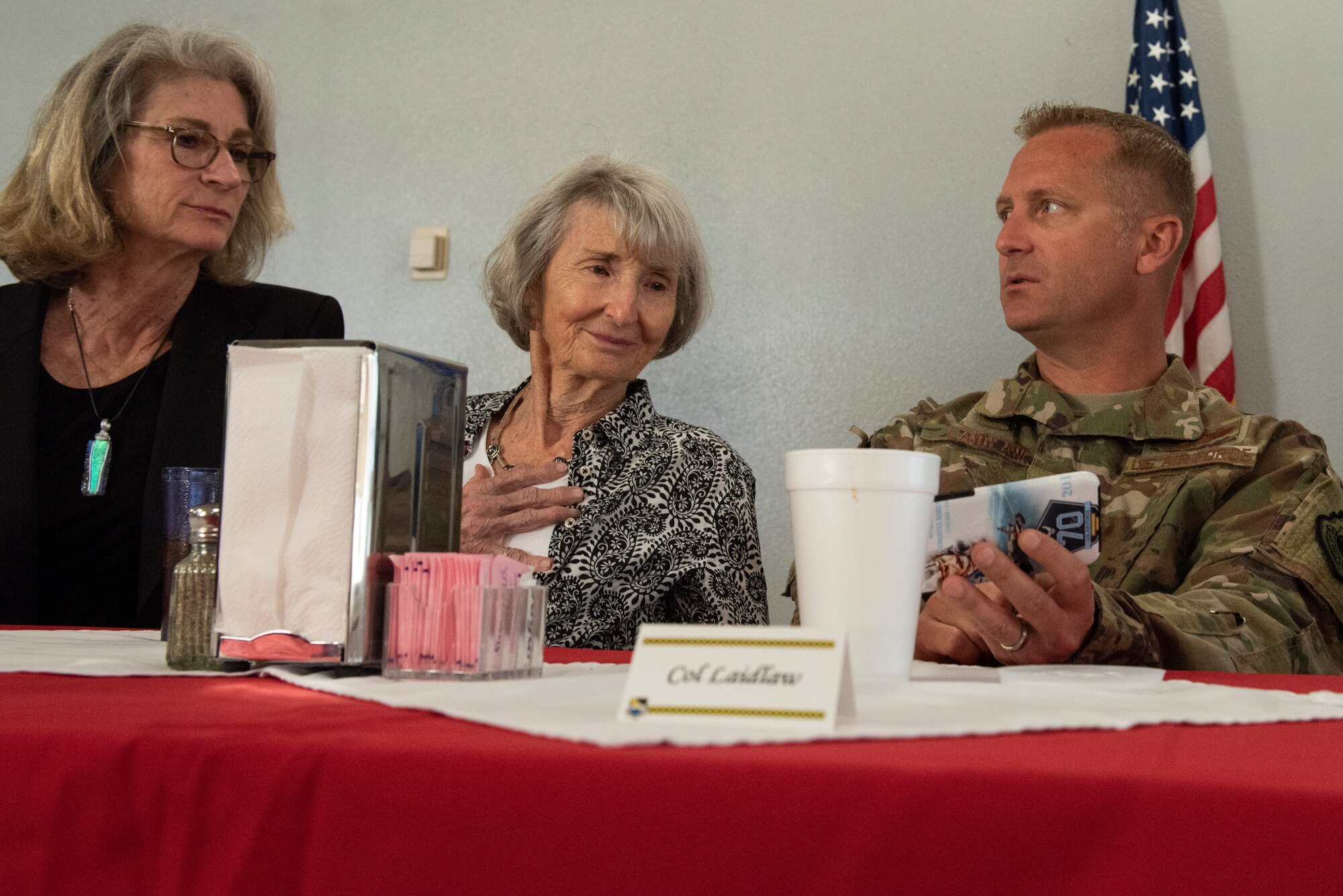 Nancy Troff, and mother Mary Tyndall Troff, daughter of World War I pilot Lt. Frank B. Tyndall, 2nd Bombardment Group, look at photos that 325th Fighter Wing Commander Brian Laidlaw saved from the initial Hurricane Michael destruction assessment during a meet and greet at Tyndall Air Force Base, Fla., Feb. 25, 2019. Mary and her daughters were invited to visit TAFB after she sent a letter about her concerns for the base and the well-being of Airmen after Hurricane Michael. (U.S. Air Force photo by Staff Sgt. Alexandre Montes)