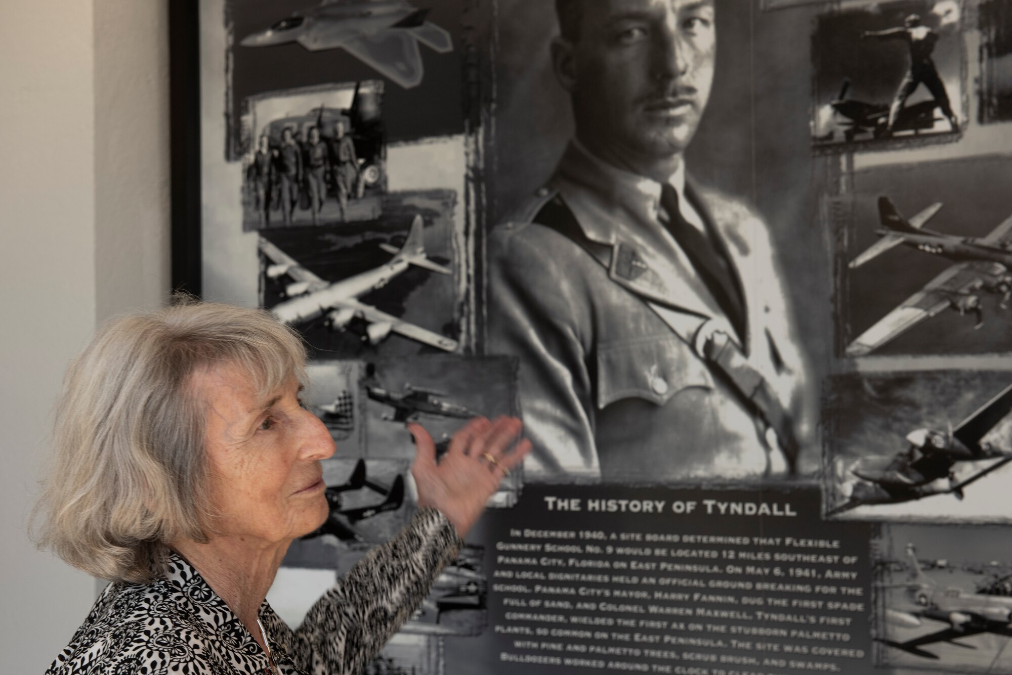 Mary Tyndall Troff, daughter of World War I pilot Lt. Frank B. Tyndall, 2nd Bombardment Group, stands in front of a heritage mural inside the 325th Fighter Wing headquarters building during a base visit at Tyndall Air Force Base, Fla., Feb. 25, 2019. Mary and her daughters were invited to visit TAFB after she sent a letter about her concerns for the base and the well-being of Airmen after Hurricane Michael. (U.S. Air Force photo by Staff Sgt. Alexandre Montes)