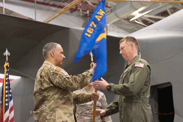 Lt. Col. Christopher Sigler accepts the 167th Mission Support guidon from Col. David Cochran, 167th Airlift Wing commander, during his assumption of command ceremony, March 3, 2019. (U.S. Air National Guard photo by Tech. Sgt. Michael Dickson)