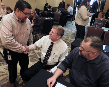 Felix Saenz, AFIMSC budget analyst for Air Force Materiel Command (left), meets Keith Tarnovich, Mission Support Group team chief, Wright-Patterson Air Force Base, Ohio, and Keith Westerbeck, Financial Management Analysis Office chief, Tinker Air Force Base, Oklahoma, during the AFIMSC Budget Officers Summit in San Antonio Feb. 28.