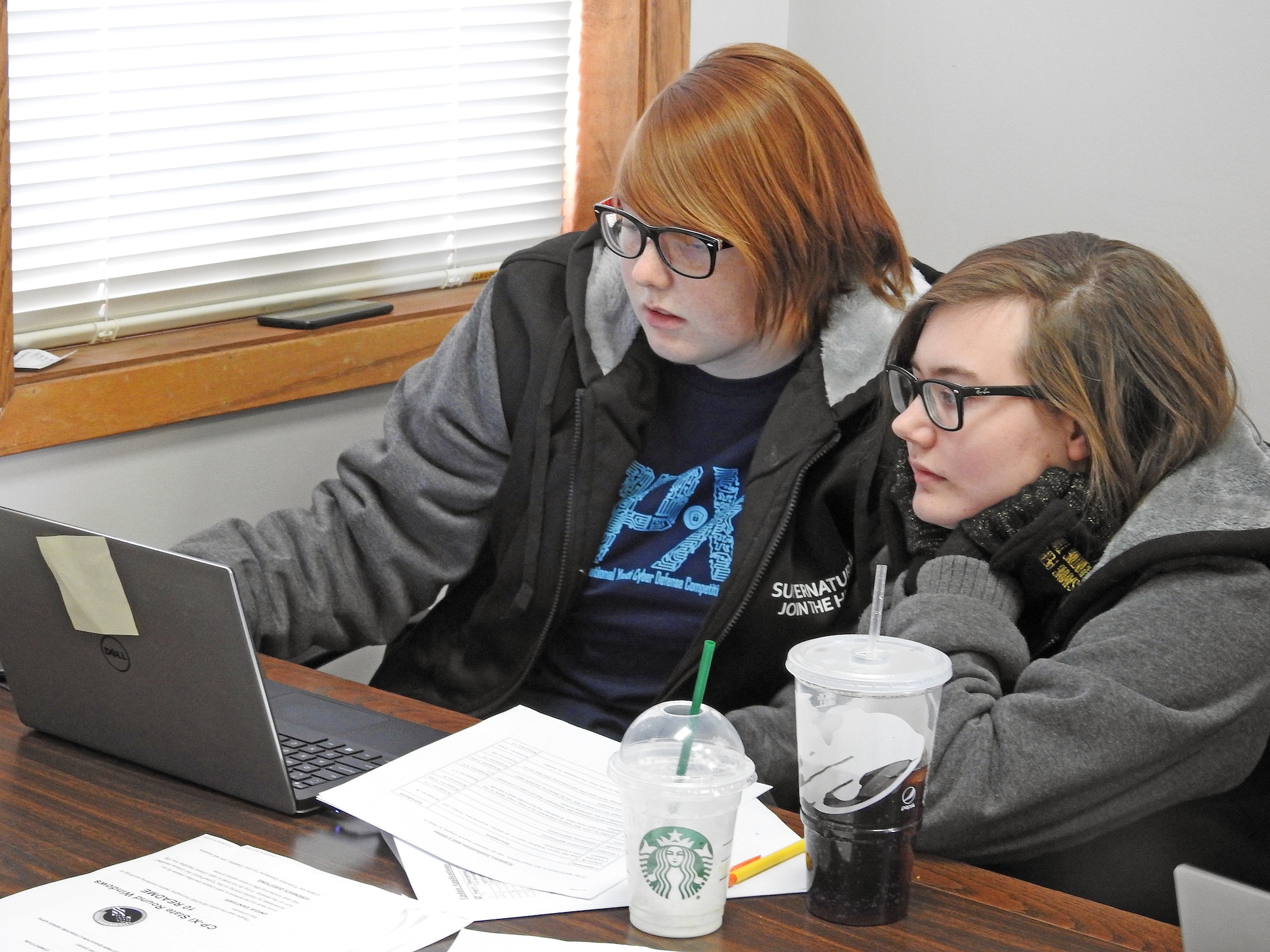 Civil Air Patrol Cadets Chief Master Sgt. Madeline Gorden and Senior Master Sgt. Cecelia Gorden look at a laptop screen Jan. 19, 2019, at the Curtis E. Lemay Civil Air Patrol Composite Squadron on Offutt Air Force Base, Neb. The squadron took part in the National CyberPatriot Competition, an event designed to inspire students toward careers in cybersecurity or other science, technology, engineering, and mathematics disciplines critical to our nation's future. (U.S. Air Force photo by Dave Farley)