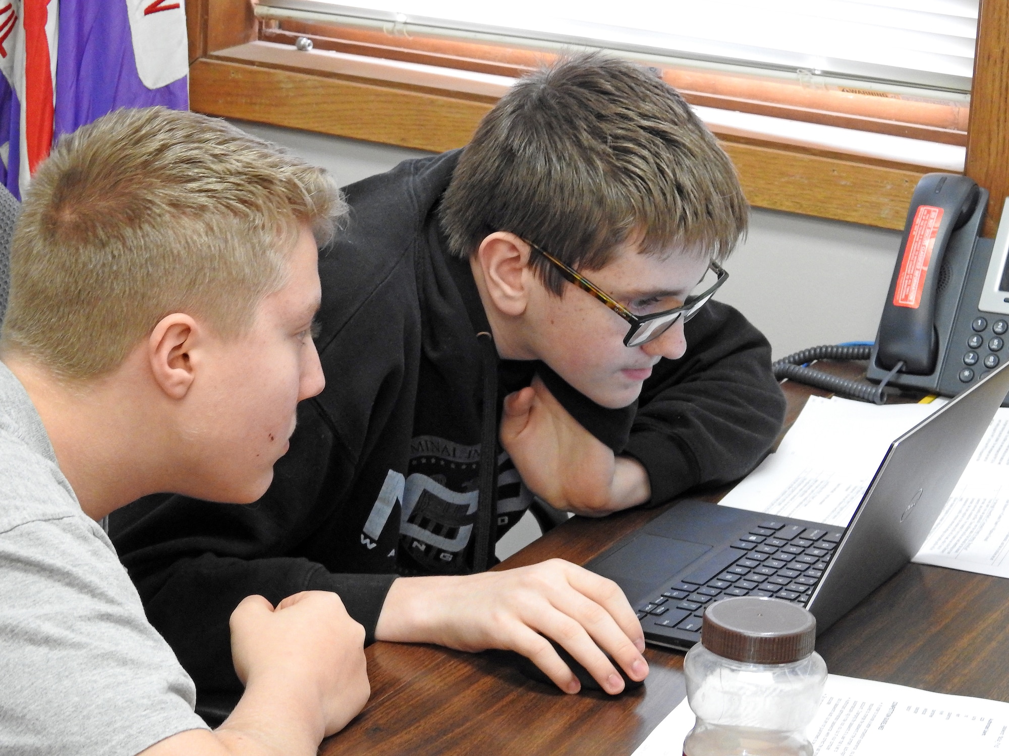 Civil Air Patrol Cadets Senior Airman Avery Broughton and Senior Master Sgt. Andrew Whelan look at a laptop screen Jan. 19, 2019, at the Curtis E. Lemay Civil Air Patrol Composite Squadron on Offutt Air Force Base, Neb. The squadron took part in the National CyberPatriot Competition, an event designed to inspire students toward careers in cybersecurity or other science, technology, engineering, and mathematics disciplines critical to our nation's future. (U.S. Air Force photo by Dave Farley)