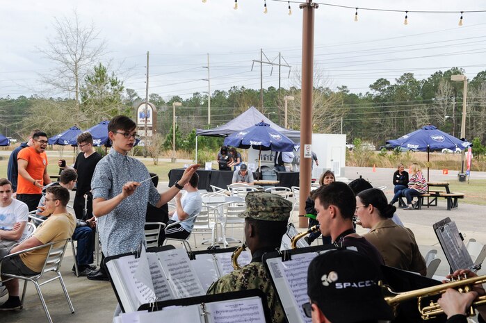 Seaman Briana Buchholtz, Navy Nuclear Power Training Command band conductor, leads the band in a performance during The Dive grand reopening ribbon cutting ceremony March 1, 2019, on the Naval Weapons Station.