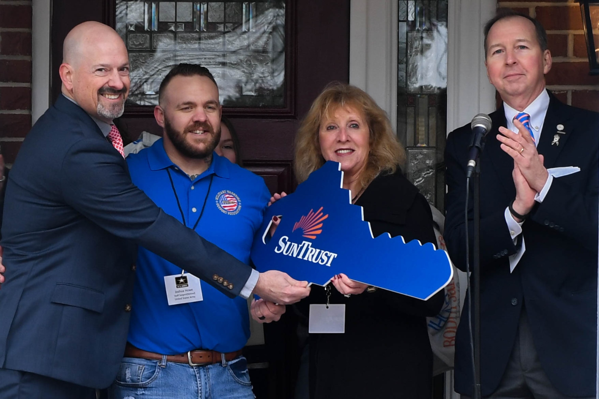 Joshua Howe, a retired U.S. Army Staff Sgt., receives the key to his new home in Newport News, Virginia, March 2, 2019. The home had been repossessed by SunTrust Bank and with the work of volunteers, fully renovated. (U.S. Air Force photo by Senior Airman Derek Seifert)