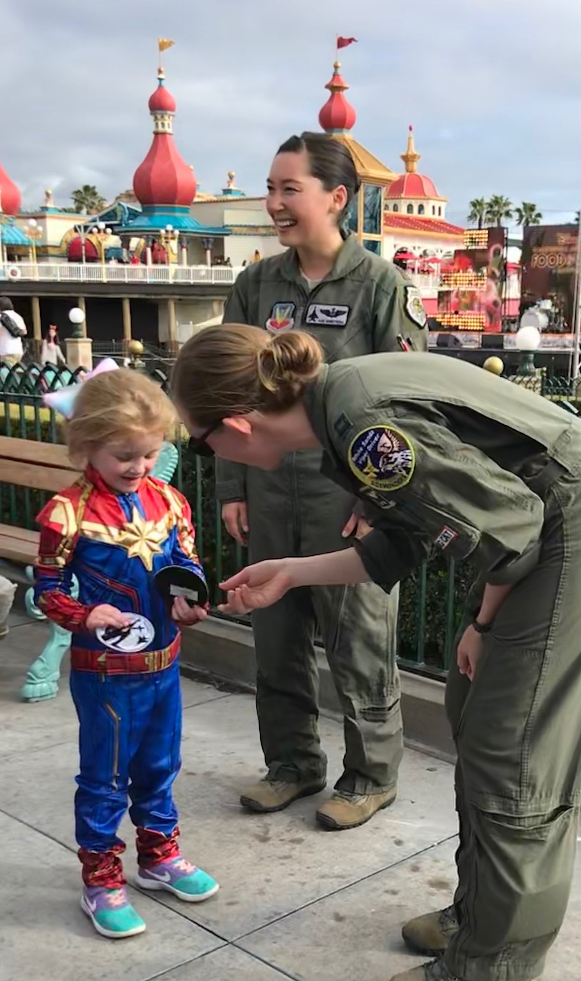 Capt. Danielle Park (right), 311th Fighter Squadron instructor pilot, hands patches to a girl dressed in a Captain Marval costume at Disney Land in Anaheim, Calif, March 3, 2019. Park was invited to attend the premiere of Captain Marval after giving the actress, Brie Larson, a ride in an F-16 Fighting Falcon while stationed at Nellis Air Force Base, Nev. (Courtesy photo)