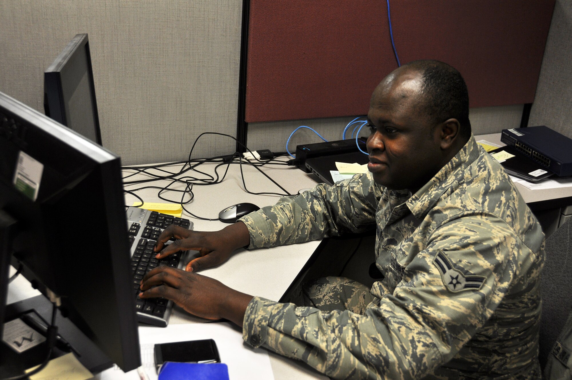 Airman 1st Class Williams Amo Ampomah, a client systems technician with the 445th Force Support Squadron communications element, troubleshoots a computer issue, one of the many tasks he does as the unit’s client systems technician.