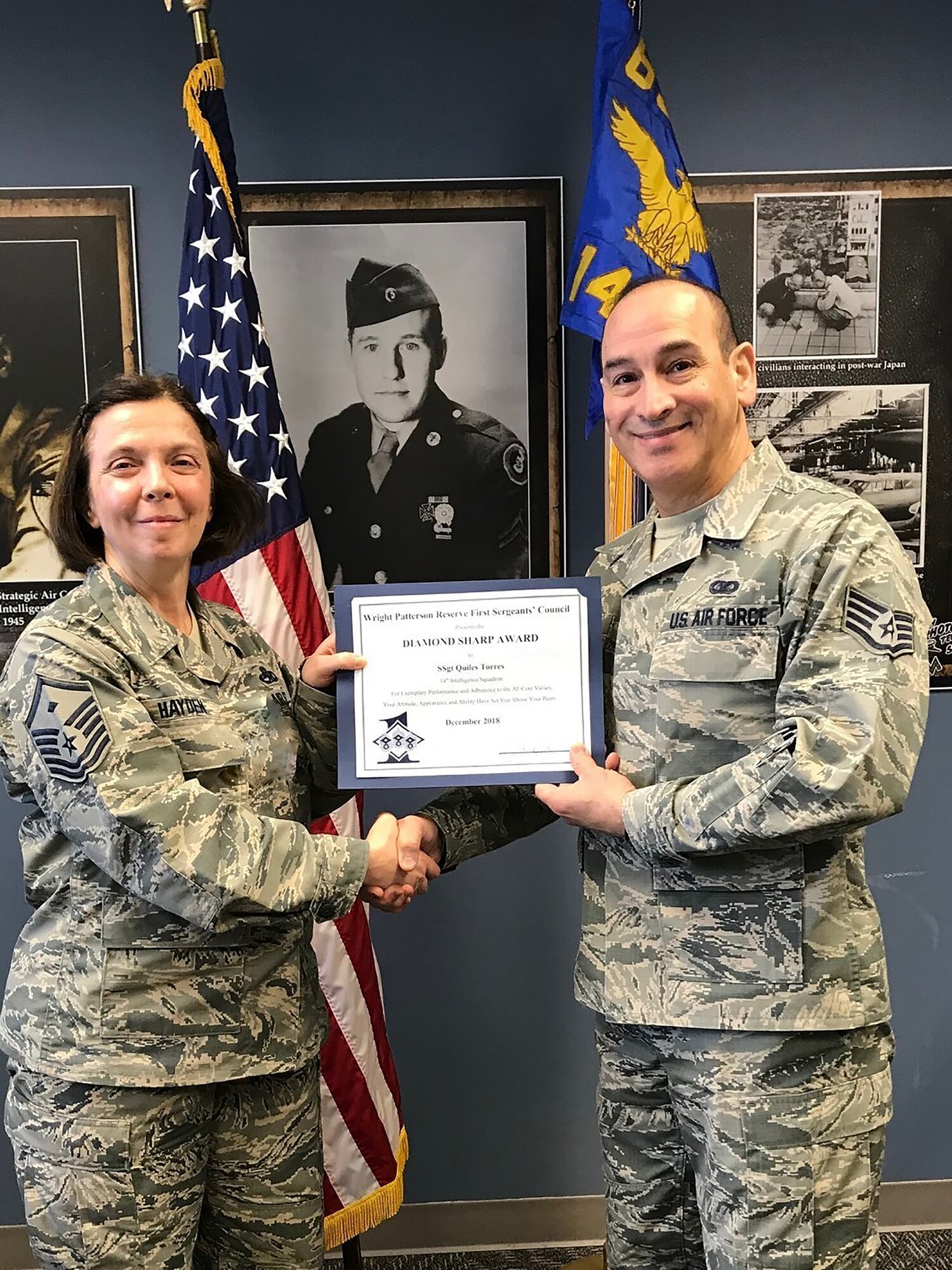 Master Sgt. Angela Hayden, 14th Intelligence Squadron first squadron, presents the December 2018 Diamond Sharp award on behalf of the Wright-Patterson Air Force Base Reserve First Sergeant Council to Staff Sgt. Dennis Quiles Torres, 14 IS CSS Administration Journeyman, for outstanding appearance and superb performance of duties for the month of December 2018.