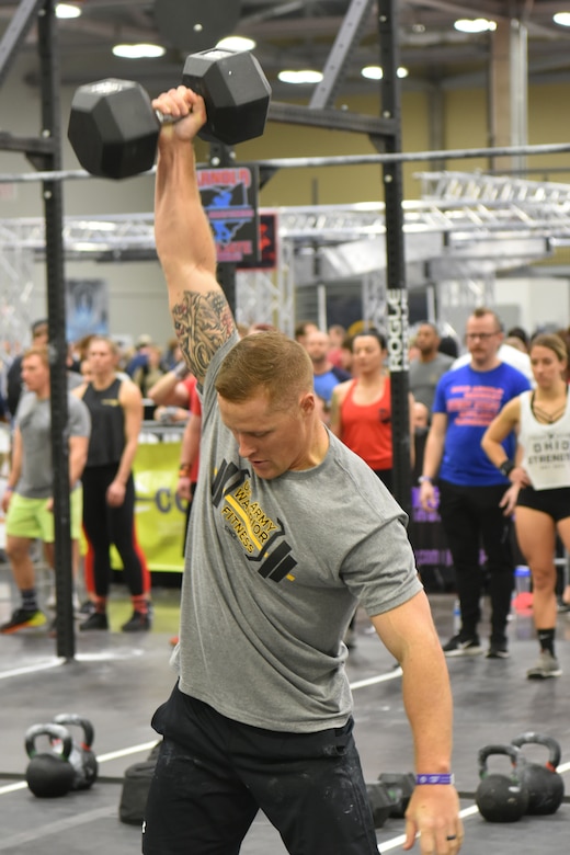 Harris performing a 50 lb. dumbbell snatch.