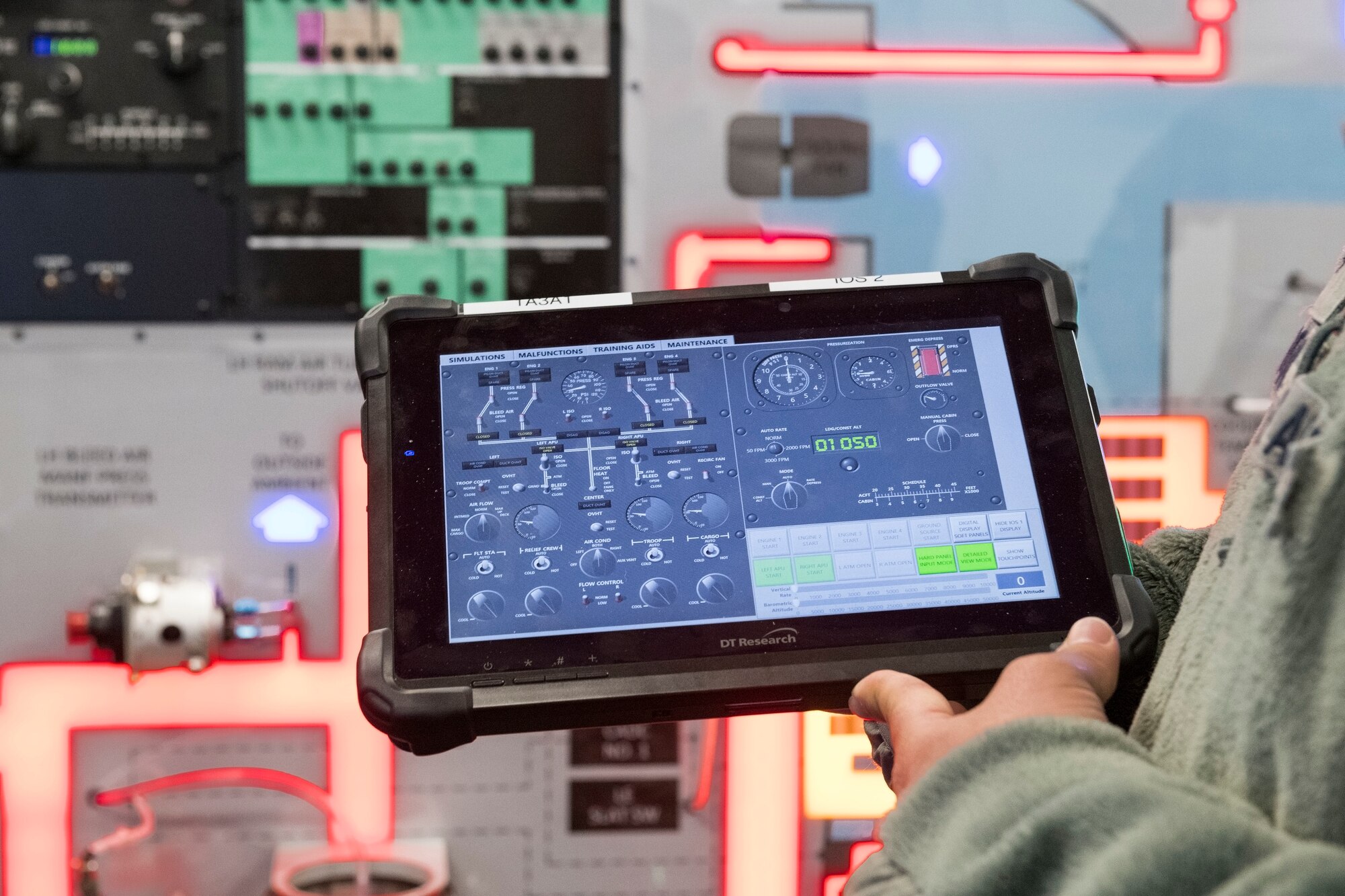Staff Sgt. Jose Cardona, 373rd Training Squadron, Detachment 3, C-5M Electrical and Environmental Systems instructor, holds the Interactive Multimedia Instruction tablet for the C-5 Air Conditioning and Pressurization Systems Trainer Feb. 20, 2019, at the 373rd TRS, Det 3, on Dover Air Force Base, Del. The IMI allows Cardona to train students on the AC & PST by monitoring actions, inputting malfunctions and simulating on-the-ground or inflight scenarios.(U.S. Air Force photo by Roland Balik)