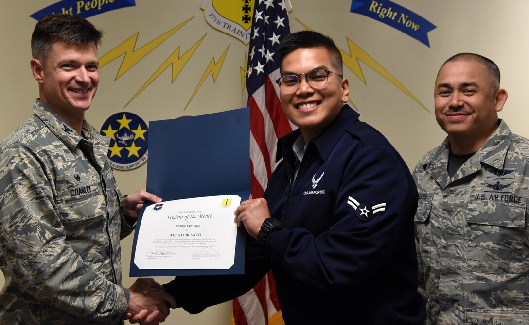 U.S. Air Force Col. Thomas Coakley, 17th Training Group commander, presents the 315th Training Squadron Student of the Month award to Airman 1st Class Axl Blanco, 315th TRS student, at the Brandenburg Hall on Goodfellow Air Force Base, Texas, March 1, 2019. The 315th TRS’s vision is to develop combat-ready intelligence, surveillance and reconnaissance professionals and promote an innovative squadron culture and identity unmatched across the U.S. Air Force. (U.S. Air Force photo by Airman 1st Class Abbey Rieves/Released)