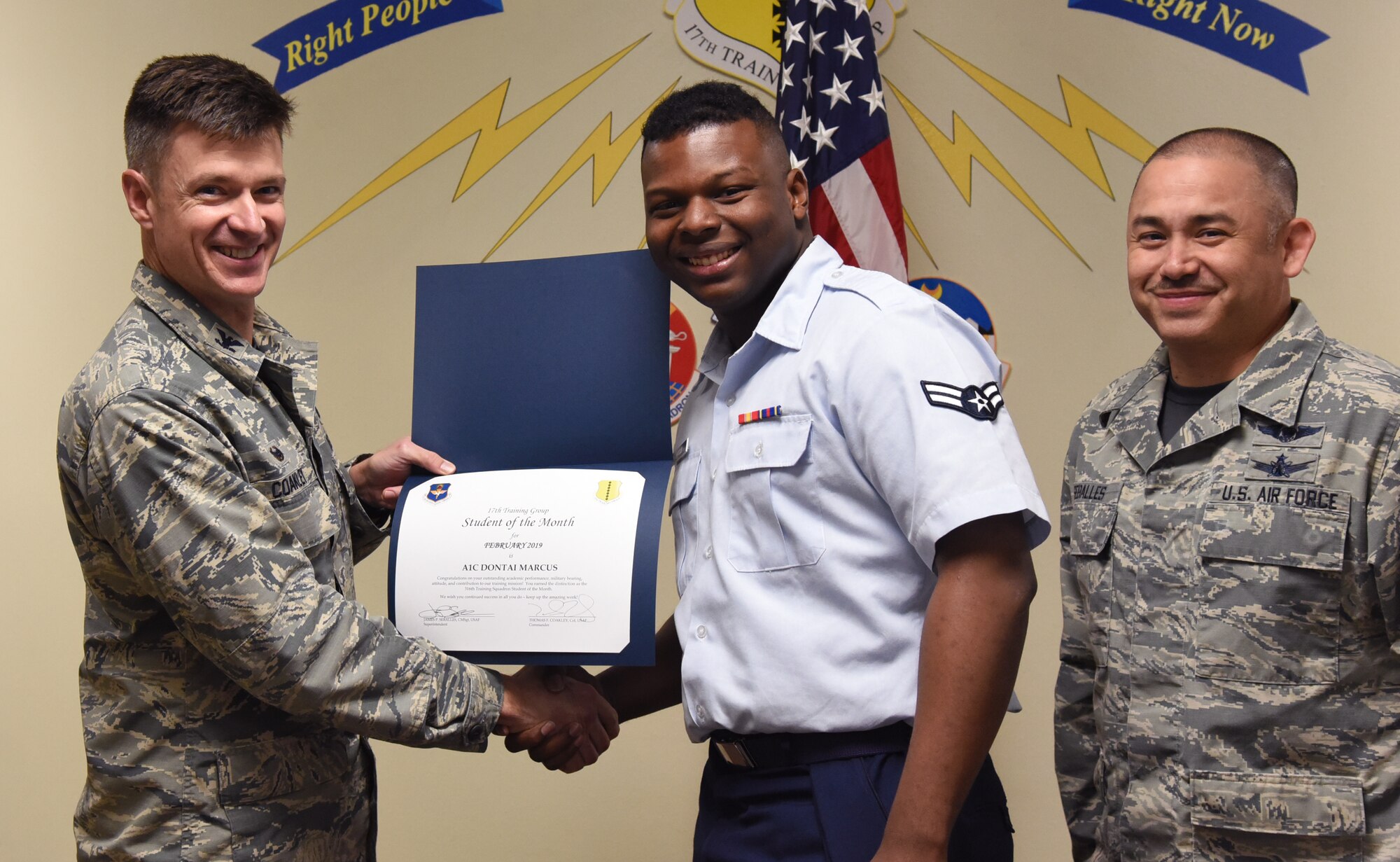 U.S. Air Force Col. Thomas Coakley, 17th Training Group commander, presents the 316th Training Squadron student, award to Airman 1st Class Dontai Marcus, 316th TRS student, at the Brandenburg Hall on Goodfellow Air Force Base, Texas, March 1, 2019. The 316th TRS’s mission is to conduct U.S. Air Force, U.S. Army, U.S. Marine Corps, U.S. Navy and U.S. Coast Guard cryptologic, human intelligence and military training. (U.S. Air Force photo by Airman 1st Class Abbey Rieves/Released)