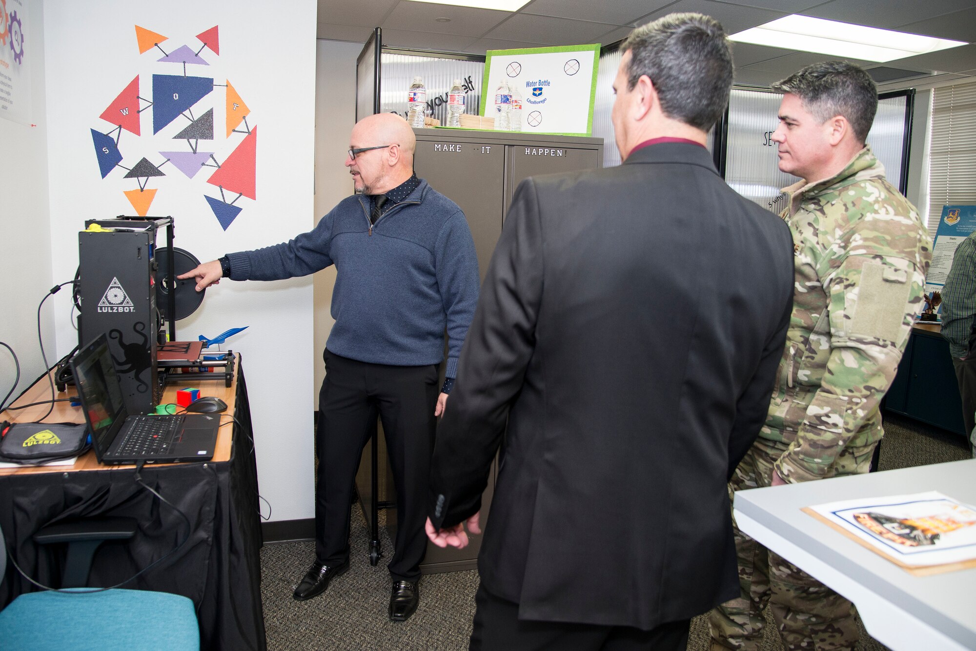 Brian Marchitello (left) Sean Harrington from the Air Education and Training Command Innovation Advancement Division, highlight the 3D printing capabilities of the "Fire Pit" to Col. Jason Lamb, AETC's Director of Intelligence, Analysis, and Innovation, March 5, 2019, at Joint Base San Antonio-Randolph, Texas. The 3D print capability is just one of the tools in the Fire Pit designed to help innovators across the command use technology as part of the effort to see how people can learn more effectively.  (U.S. Air Force photo by Sean Worrell)