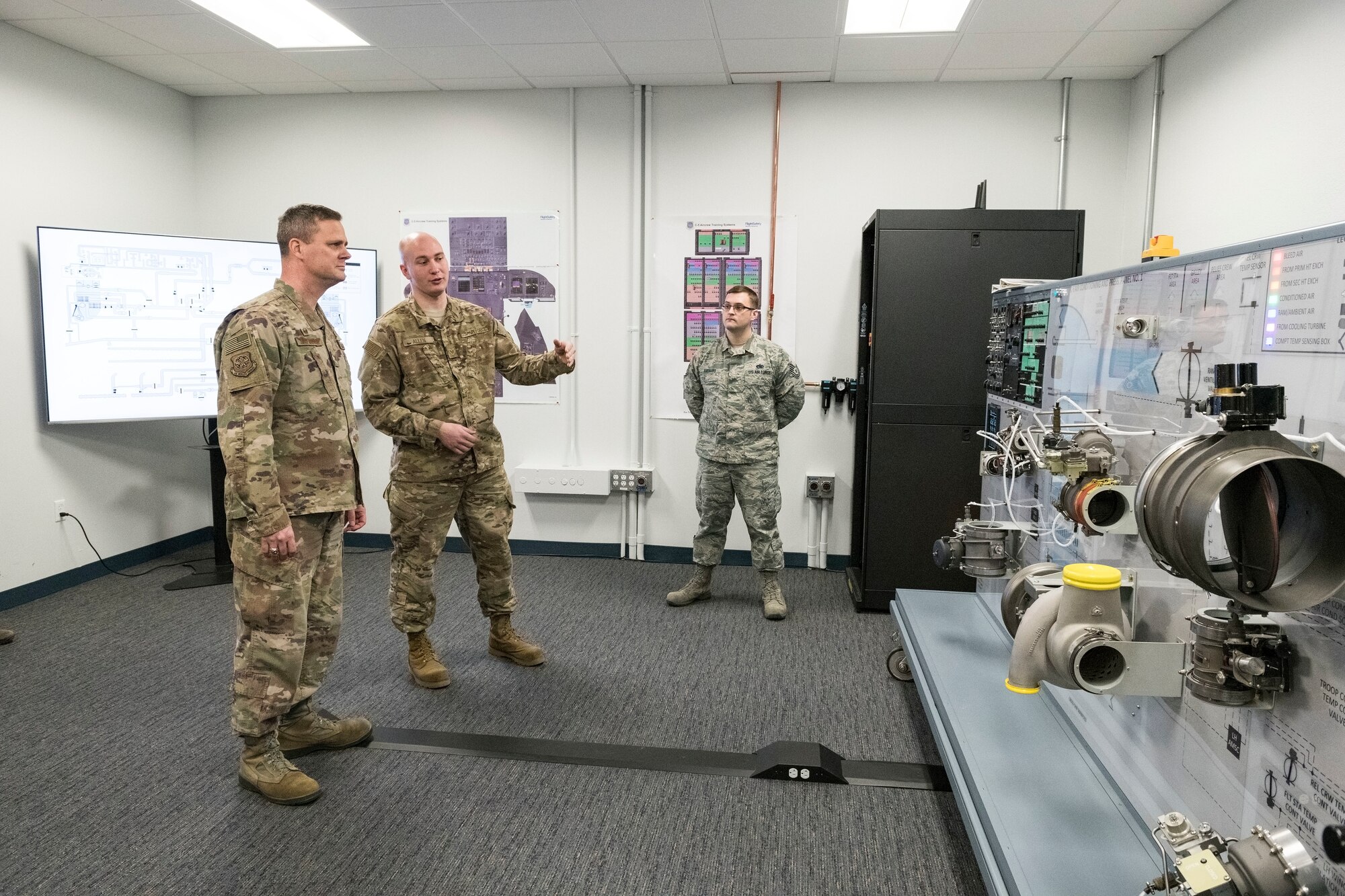 From left to right, Col. Joel Safranek, 436th Airlift Wing commander, listens to Staff Sgt. Damien Allen, 373rd Training Squadron, Detachment 3, C-5M trainer development and subject matter expert, explain the history and process of updating both of the legacy C-5 Air Conditioning and Pressurization Systems Trainers Feb. 20, 2019, at the 373rd Training Squadron, Detachment 3, on Dover Air Force Base, Del. The upgraded AC & PSTs are valued at $5.9 million dollars each and took 12 months to convert to the C-5M Super Galaxy configuration. (U.S. Air Force photo by Roland Balik)
