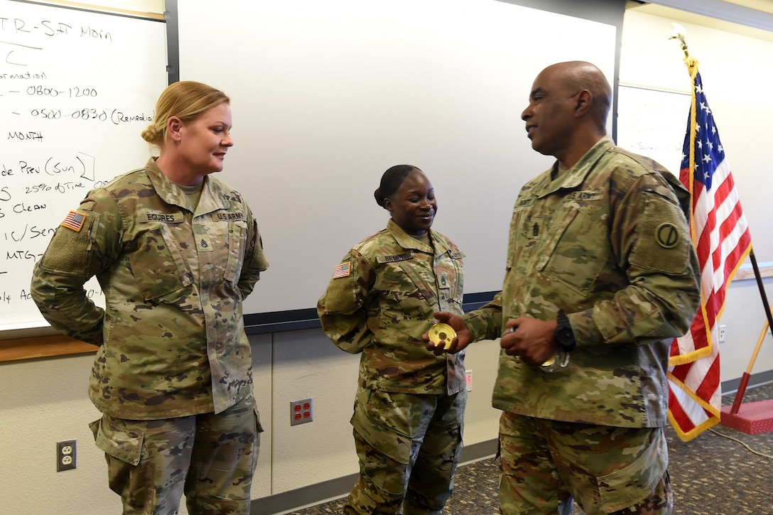 Command Sgt. Maj. Theodore Dewitt, right, Command Sergeant Major, 85th U.S. Army Reserve Support Command, presents coins to Soldiers from 1st Battalion, 382nd Regiment, 85th U.S. Army Reserve Support Command, operationally controlled by First Army’s 5th Armored Brigade, during a command site visit, there, at Fort Bliss, Texas, March 1-3, 2019.