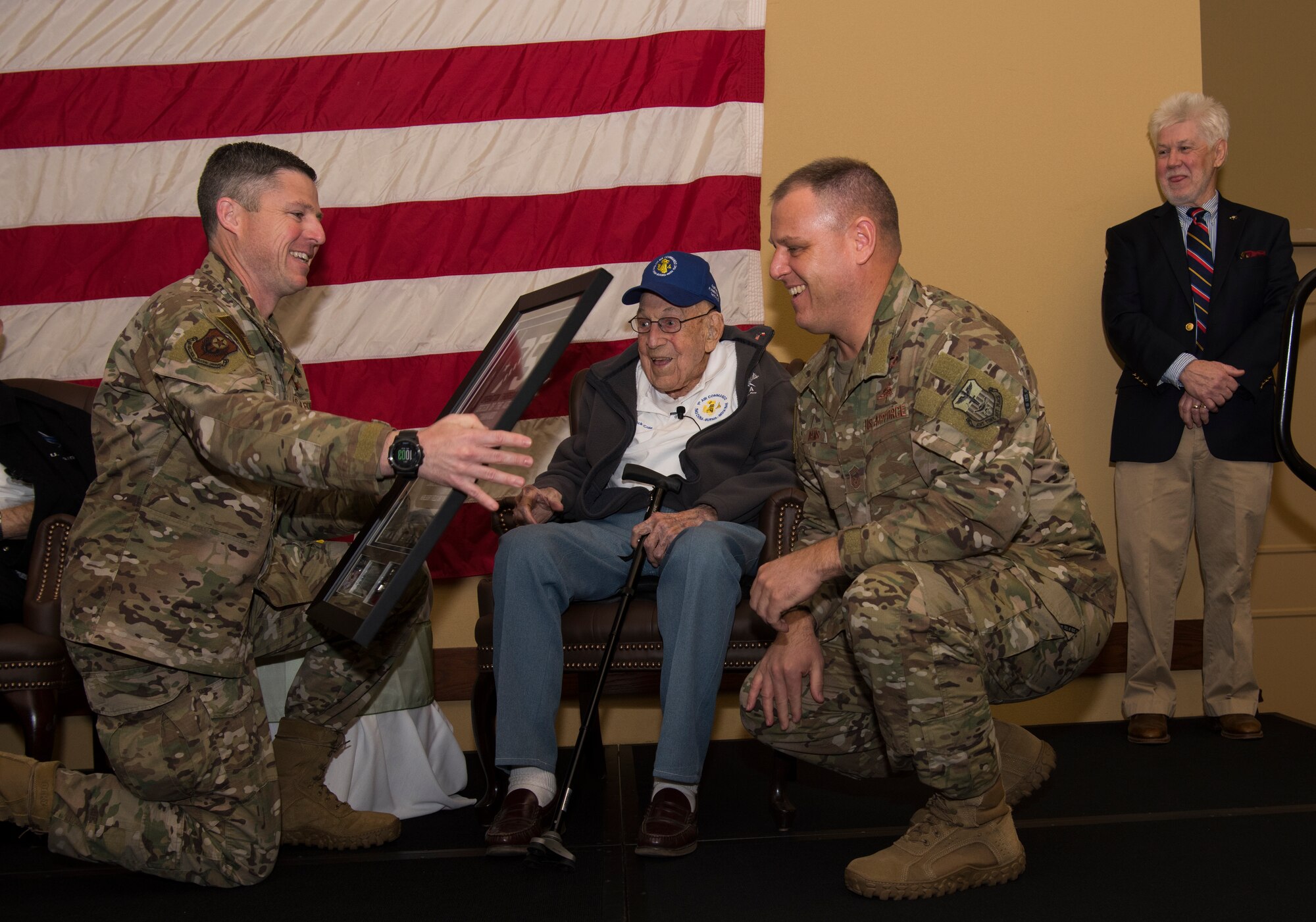 1st Special Operations Wing leadership presenting plaque to WW II veteran.