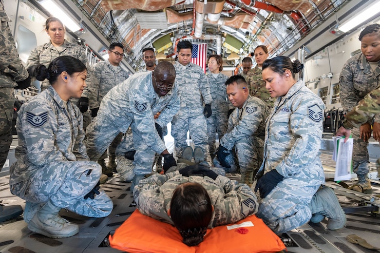 U.S. Air Force Tech. Sgt. Donahue Pinto, of Ewa Beach, Hawaii, a member of the Air Force Reserve’s 624th Aeromedical Staging Squadron, provides instruction on how to properly secure a patient for movement during an aeromedical staging and aerial port training at Joint Base Pearl Harbor-Hickam, Hawaii, March 3, 2019.