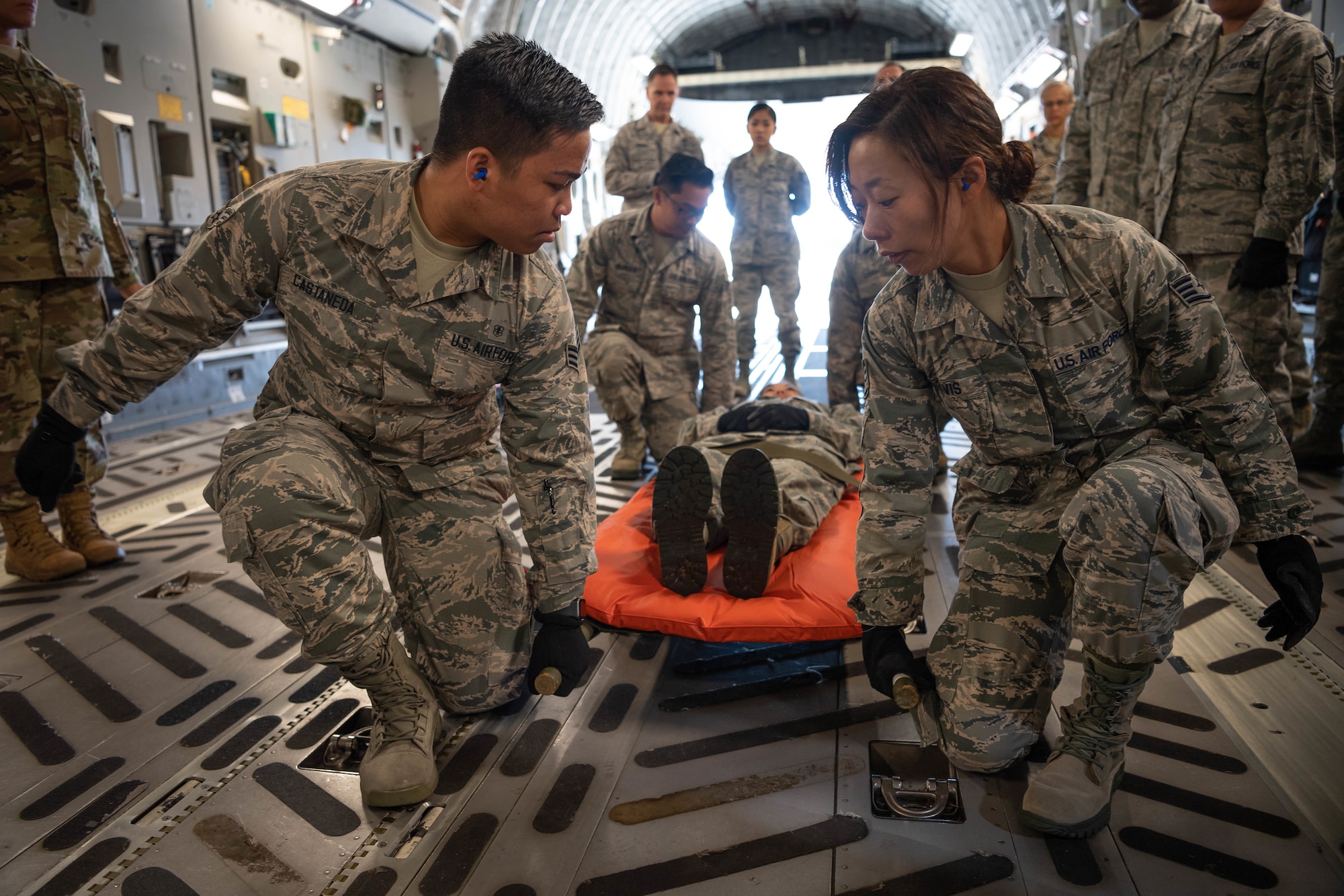 U.S. Air Force Senior Airman Eunel John Castaneda and Staff Sgt. Alexandria Davis members of the Air Force Reserve’s 624th Aeromedical Staging Squadron, carry a simulated patient, Chief Master Sgt. Danyell Stoutamire, during an aeromedical staging and aerial port training at Joint Base Pearl Harbor-Hickam, Hawaii, March 3, 2019.