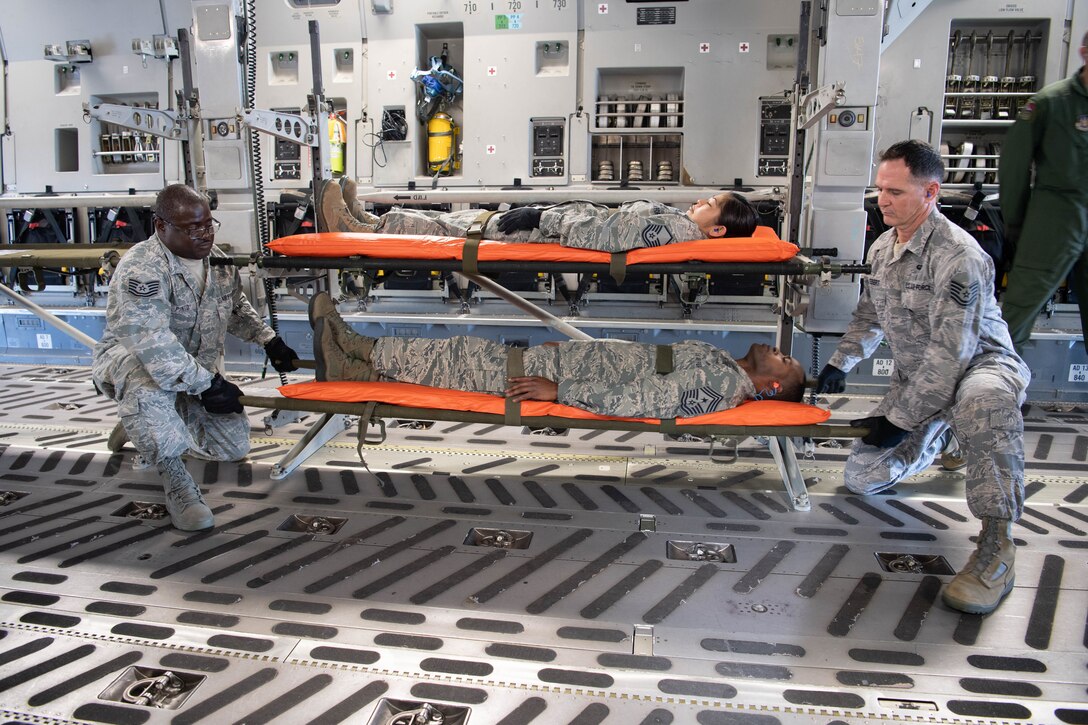 U.S. Air Force Tech. Sgts. Donahue Pinto and Scott Ebert both members of the Air Force Reserve’s 624th Aeromedical Staging Squadron, carry a simulated patient, Chief Master Sgt. Danyell Stoutamire, during an aeromedical staging and aerial port training at Joint Base Pearl Harbor-Hickam, Hawaii, March 3, 2019.