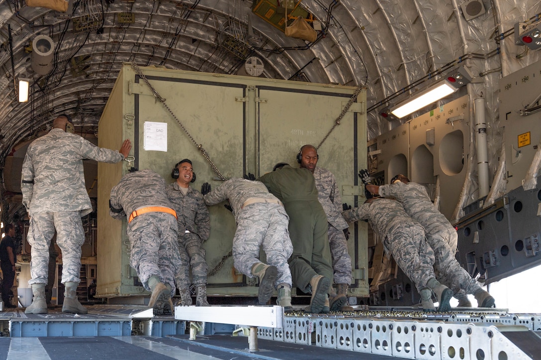 A team of Reserve Citizen Airmen from the 48th Aerial Port Squadron and Hawaii Air National Guard loadmasters load equipment onto a U.S. Air Force C-17 Globemaster III aircraft during an aeromedical staging and aerial port training at Joint Base Pearl Harbor-Hickam, Hawaii, March 3, 2019.