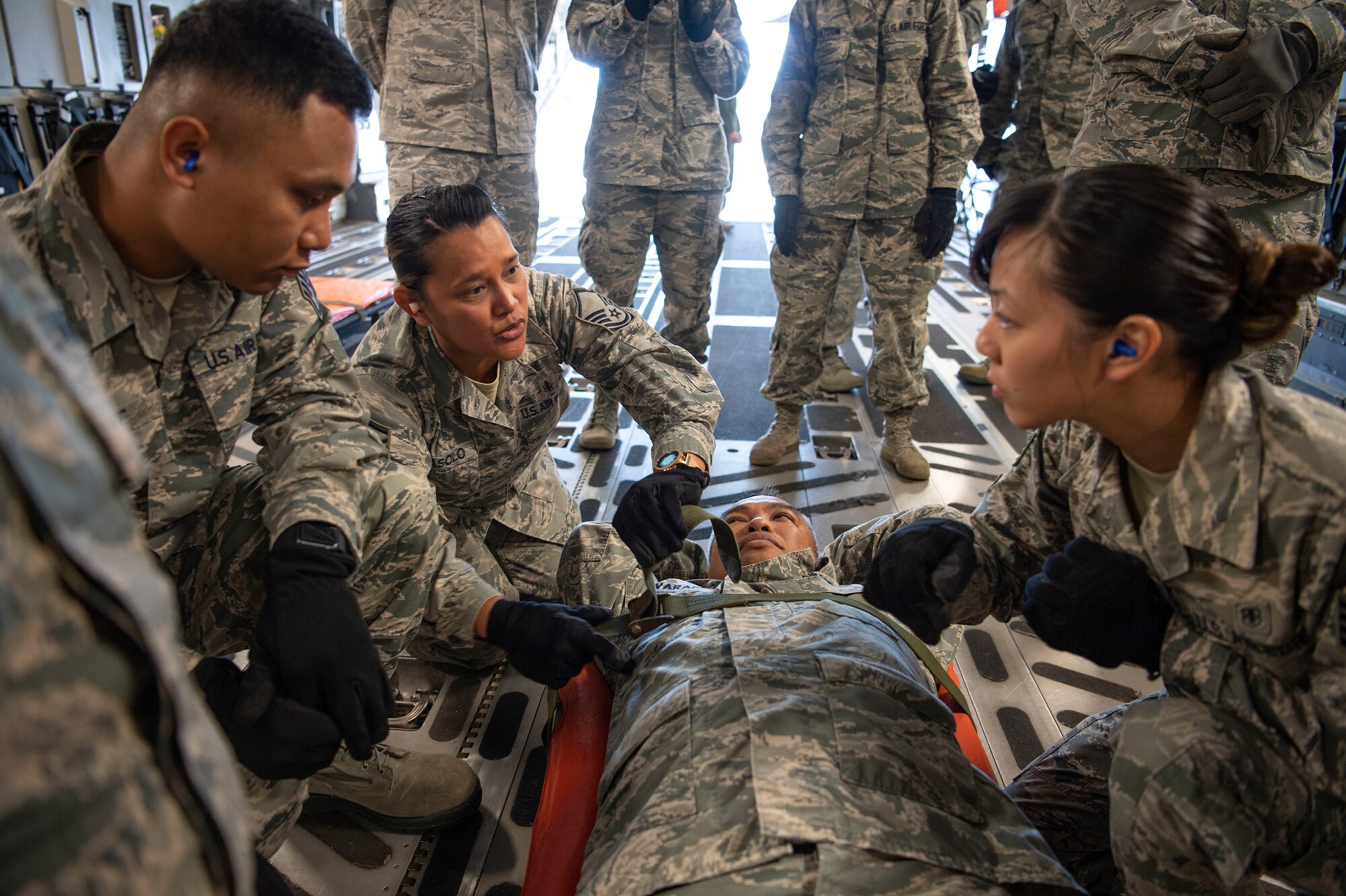 U.S. Air Force Master Sgt. Tatiana Abasolo, a member of the Air Force Reserve’s 624th Aeromedical Staging Squadron, provides instruction on how to properly secure a patient for movement during an aeromedical staging and aerial port training at Joint Base Pearl Harbor-Hickam, Hawaii, March 3, 2019.