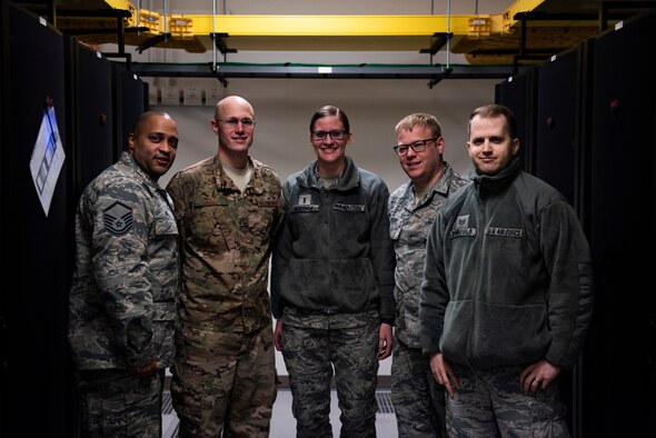 Leadership from the 8th Communications Squadron pose for a photo at Kunsan Air Base, Republic of Korea, Feb. 27, 2019. Kunsan became the first overseas Air Force base to have upgraded their email and increase storage size, paving the way for other bases to do the same. (U.S. Air Force photo by Senior Airman Stefan Alvarez)